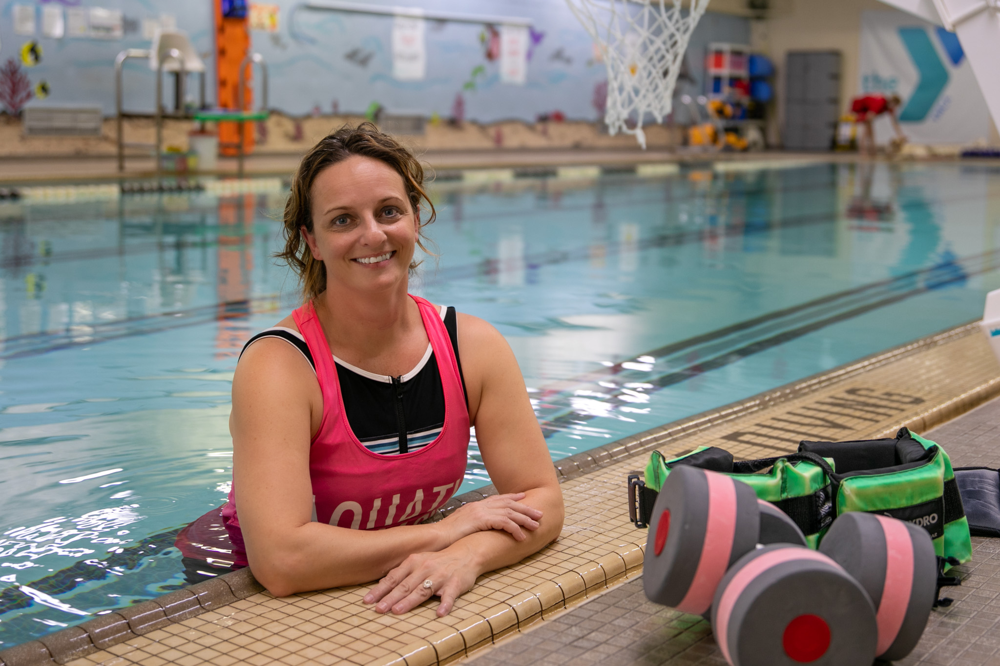 Physical Therapy Assistant smiling in the pool 